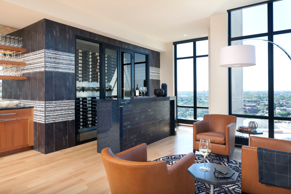 Design ideas for a mid-sized contemporary wine cellar in Minneapolis with light hardwood floors and display racks.