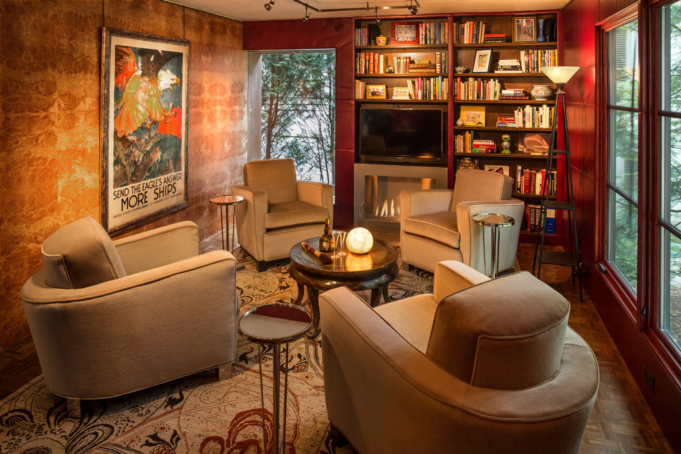 Photo of a small country enclosed family room in Milwaukee with a library, a standard fireplace, a concrete fireplace surround, a wall-mounted tv, red walls and dark hardwood floors.