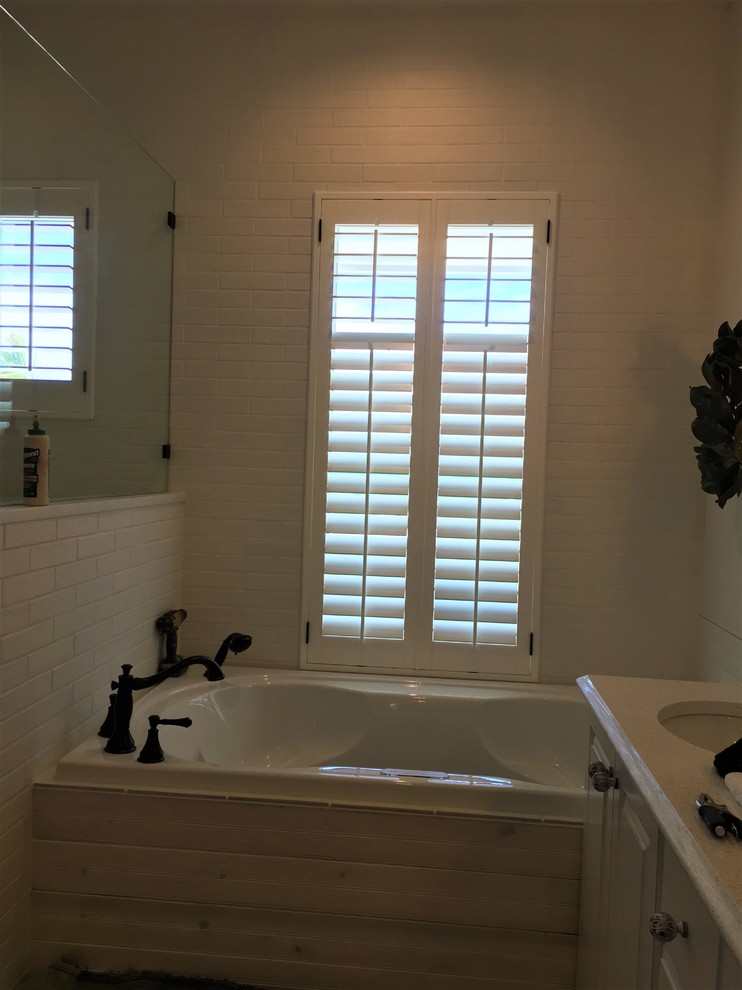 Inspiration for a large beach style master bathroom in Other with a drop-in tub, an open shower, white tile, subway tile, white walls, dark hardwood floors, brown floor and an open shower.
