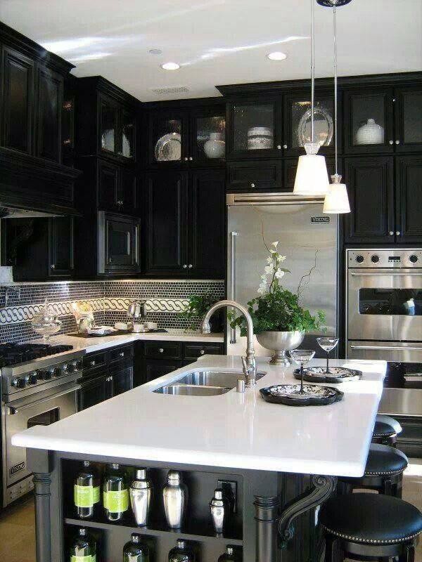 Example of a mid-sized transitional u-shaped kitchen design in Orange County with a double-bowl sink, raised-panel cabinets, black cabinets, solid surface countertops, multicolored backsplash, glass tile backsplash, stainless steel appliances and an island