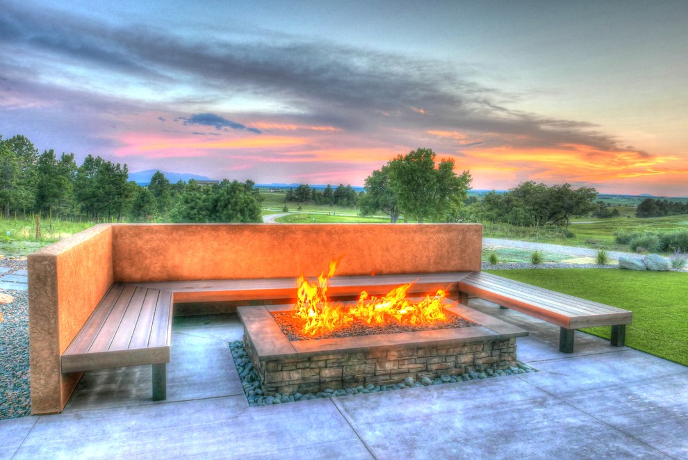 Photo of an expansive eclectic backyard partial sun xeriscape for fall in Denver with a fire feature and concrete pavers.