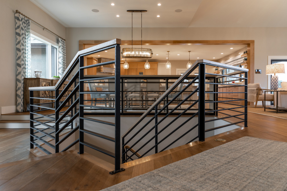 Example of a large beach style wooden l-shaped metal railing staircase design in Denver with painted risers