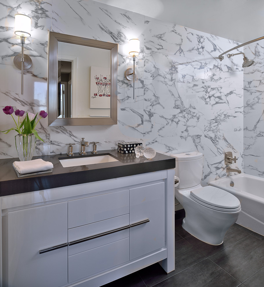 Inspiration for a contemporary bathroom in Houston with flat-panel cabinets, white cabinets, an alcove tub, a shower/bathtub combo, a two-piece toilet, white tile and white walls.