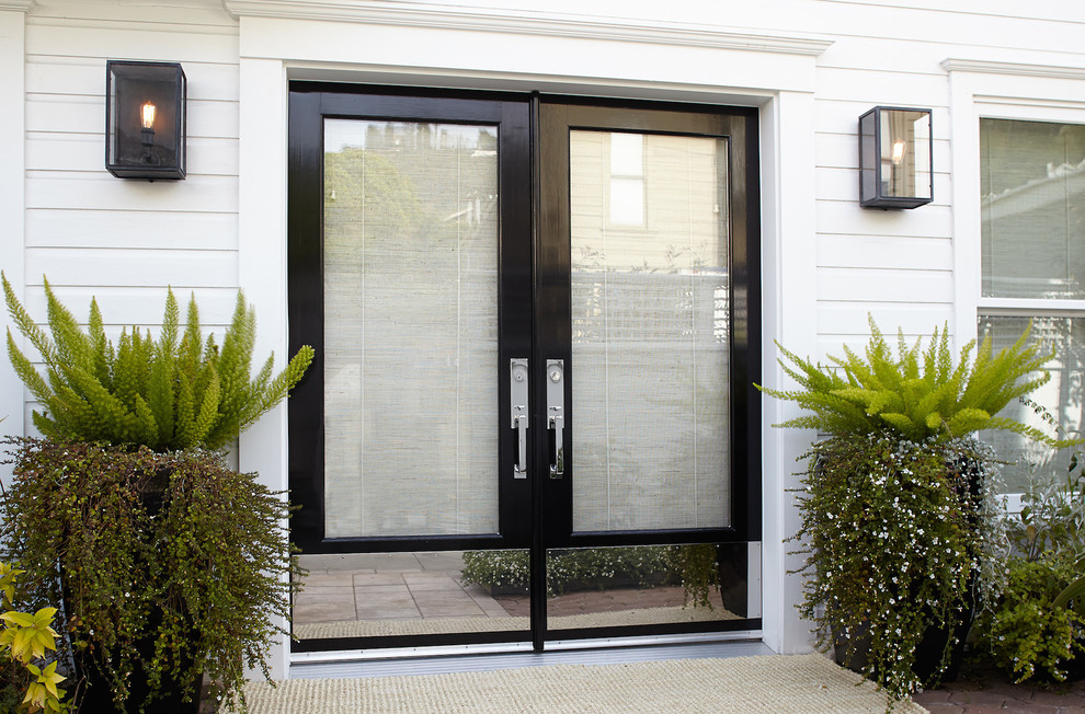 Photo of a large transitional front door in San Francisco with white walls, a double front door and a black front door.