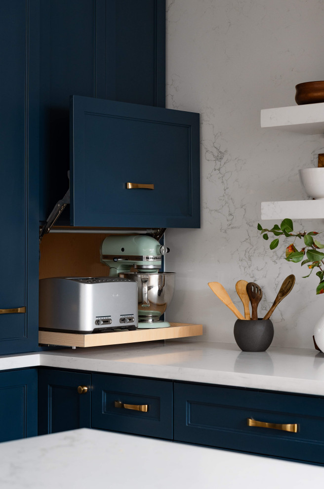 Eat-in kitchen - mid-sized transitional l-shaped medium tone wood floor and beige floor eat-in kitchen idea in Toronto with a farmhouse sink, shaker cabinets, blue cabinets, quartz countertops, white backsplash, quartz backsplash, stainless steel appliances, an island and white countertops