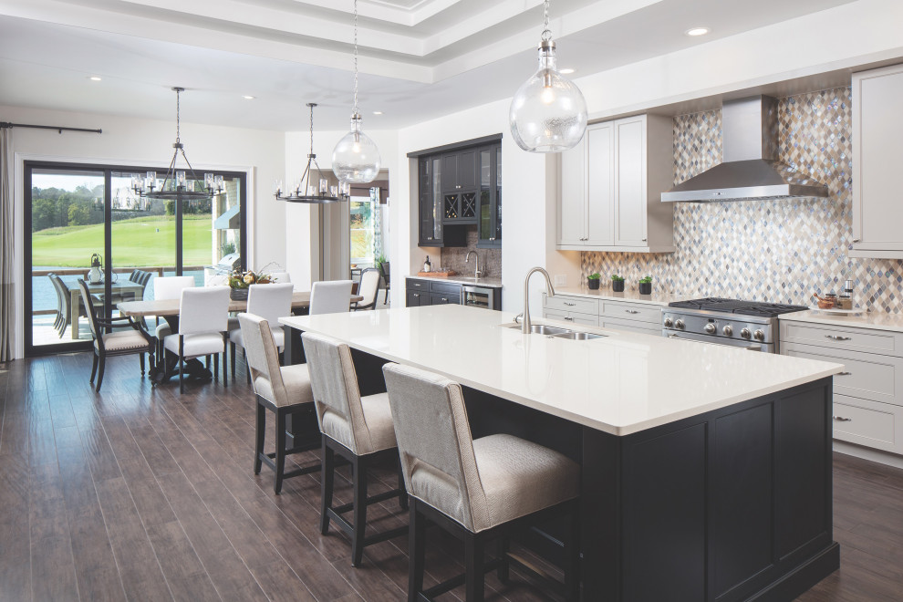 Inspiration for a l-shaped open plan kitchen in Nashville with an undermount sink, shaker cabinets, quartzite benchtops, mosaic tile splashback, stainless steel appliances, dark hardwood floors, with island and recessed.