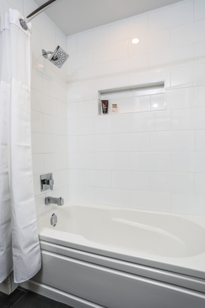 Mid-sized transitional white tile gray floor alcove bathtub photo with shaker cabinets, white cabinets, a one-piece toilet, gray walls, an undermount sink and gray countertops