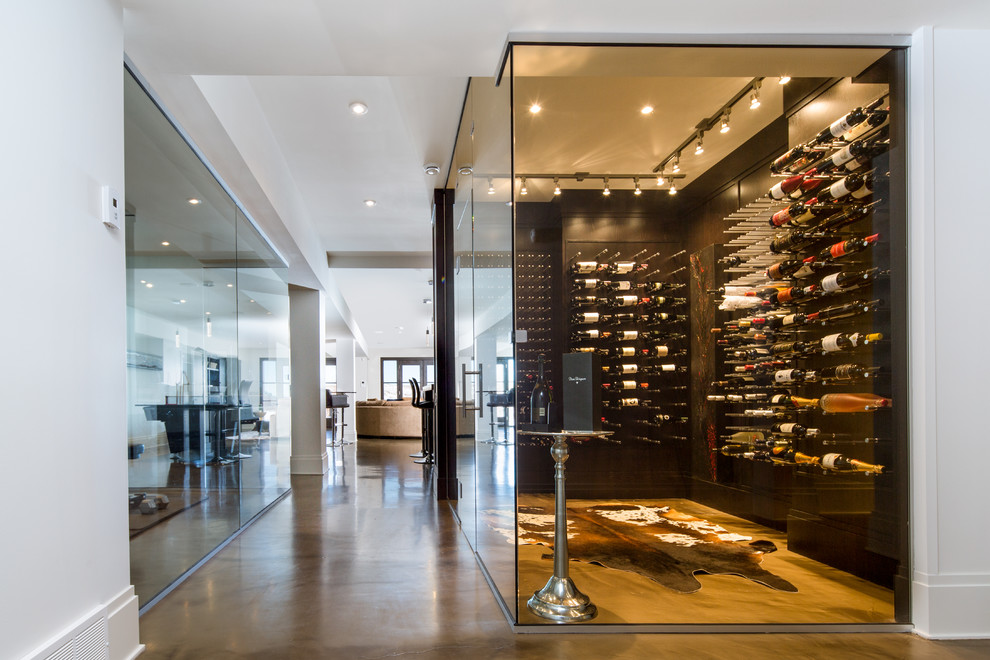 This is an example of a large modern wine cellar with limestone floors and display racks.