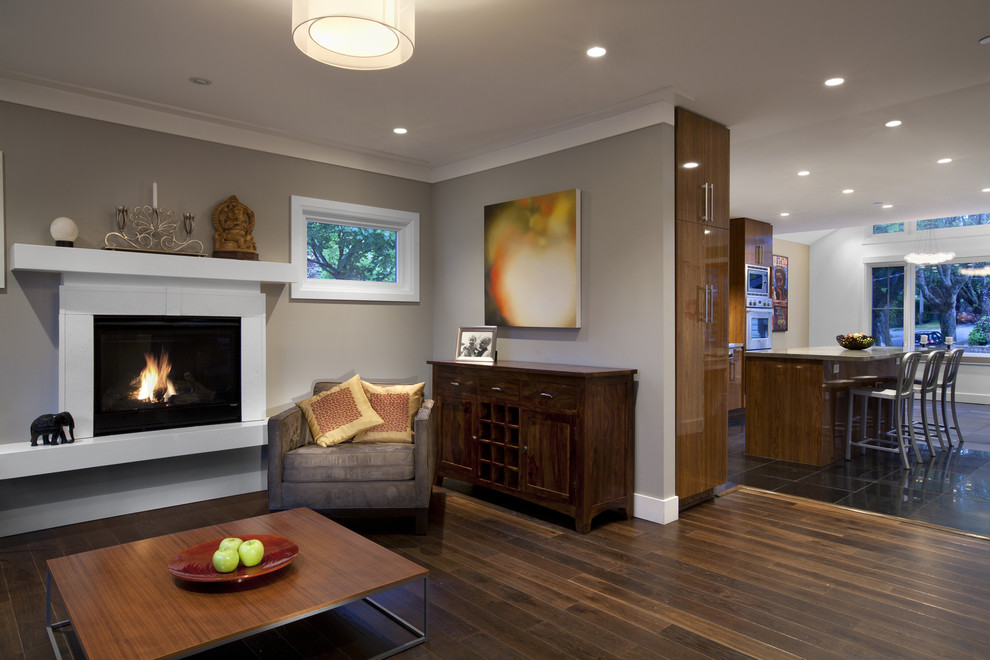 This is an example of a contemporary living room in Vancouver with grey walls and a standard fireplace.