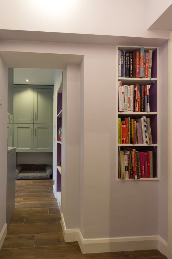 Photo of a small modern hallway in London with purple walls and porcelain floors.