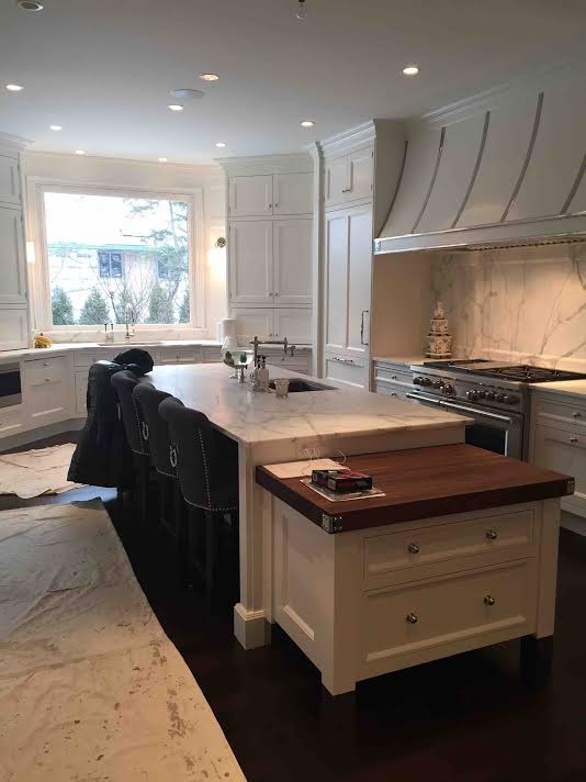 Example of a mid-sized transitional u-shaped dark wood floor eat-in kitchen design in Orange County with a double-bowl sink, raised-panel cabinets, white cabinets, marble countertops, beige backsplash, ceramic backsplash, stainless steel appliances and no island