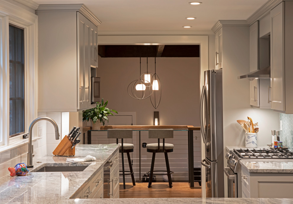 Inspiration for a transitional eat-in kitchen remodel in Boston with blue backsplash