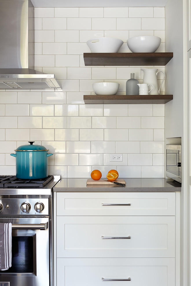 Inspiration for a large transitional medium tone wood floor kitchen remodel in Toronto with a double-bowl sink, shaker cabinets, white cabinets, quartz countertops, white backsplash, ceramic backsplash, stainless steel appliances and an island