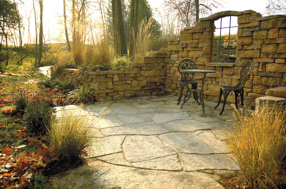 Inspiration for a mid-sized country courtyard patio in Other with no cover and natural stone pavers.