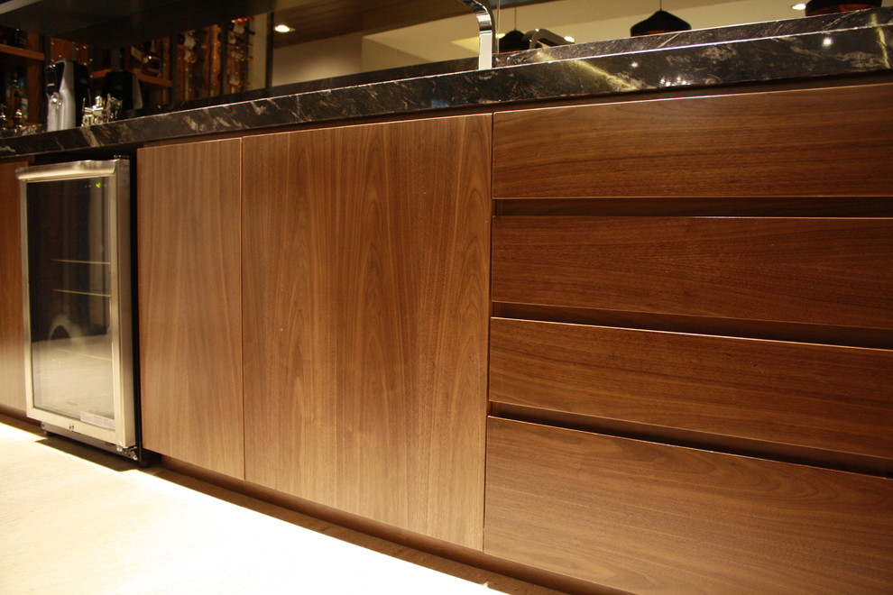 Photo of a large contemporary seated home bar in Other with flat-panel cabinets.