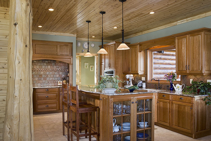 Example of a mid-sized mountain style u-shaped ceramic tile eat-in kitchen design in Albuquerque with an undermount sink, raised-panel cabinets, medium tone wood cabinets, granite countertops, ceramic backsplash, stainless steel appliances and an island
