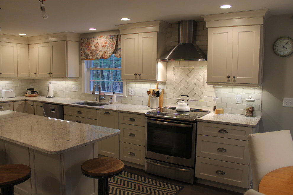Design ideas for a large traditional l-shaped eat-in kitchen in Boston with an undermount sink, recessed-panel cabinets, white cabinets, granite benchtops, white splashback, subway tile splashback, stainless steel appliances, ceramic floors and with island.