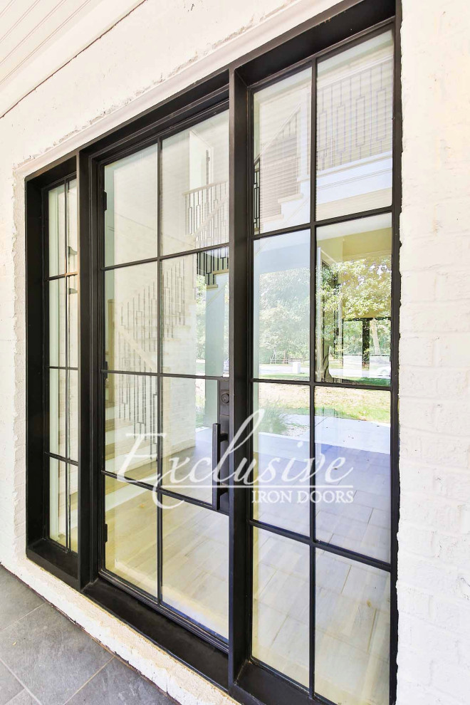 This is an example of a mid-sized contemporary front door in Austin with white walls, a single front door and a black front door.