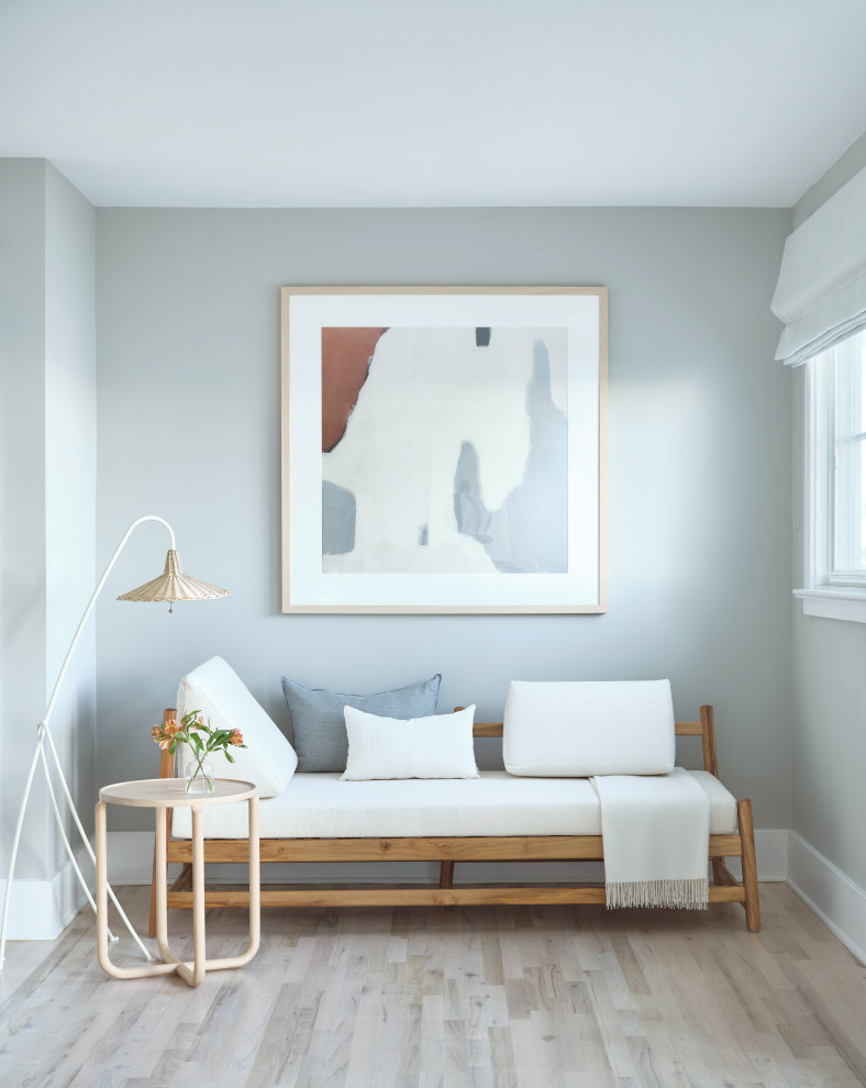 Inspiration for a mid-sized beach style master bedroom in New York with grey walls, light hardwood floors, no fireplace and brown floor.