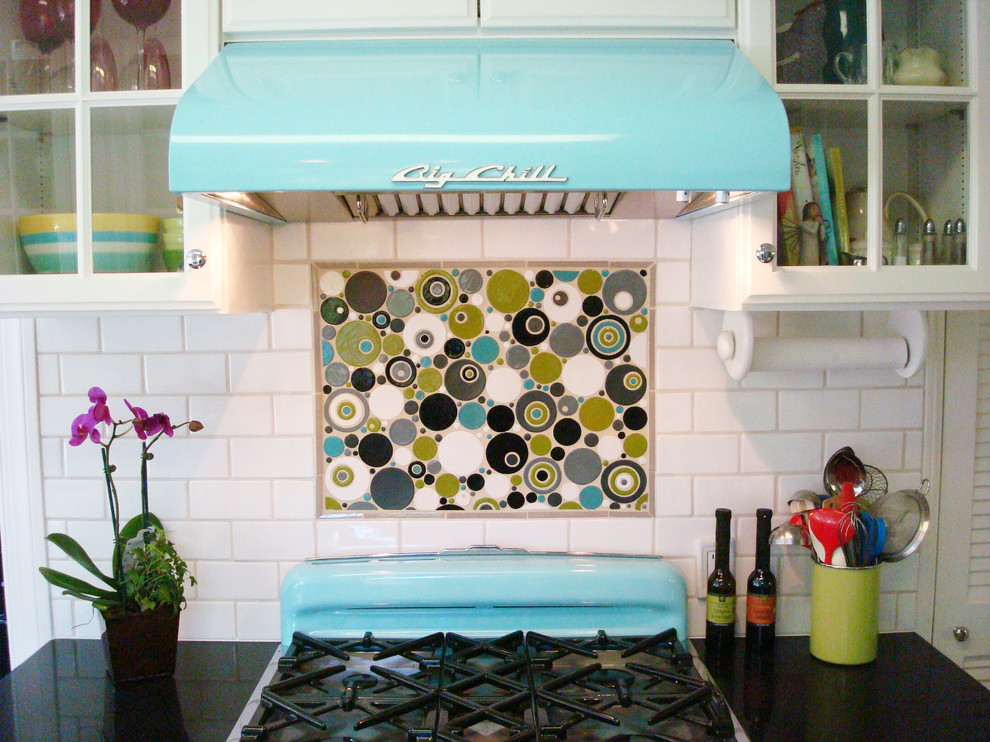 Mid-sized eclectic galley separate kitchen in Los Angeles with a farmhouse sink, glass-front cabinets, white cabinets, white splashback, subway tile splashback, coloured appliances, quartz benchtops, no island and vinyl floors.