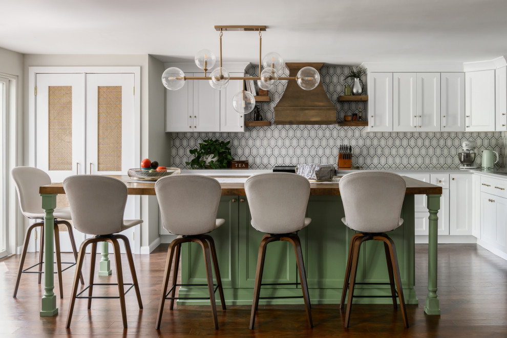 Mid-sized eclectic laminate floor and brown floor kitchen photo in Philadelphia with an undermount sink, quartz countertops, multicolored backsplash, marble backsplash, stainless steel appliances, an island and gray countertops