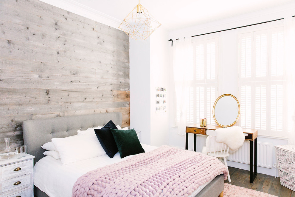 Inspiration for a mid-sized scandinavian bedroom in London with white walls, dark hardwood floors and brown floor.