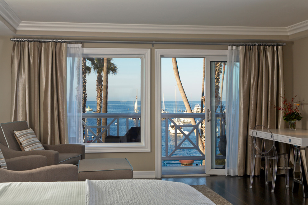 Design ideas for a mid-sized beach style master bedroom in Los Angeles with beige walls and dark hardwood floors.