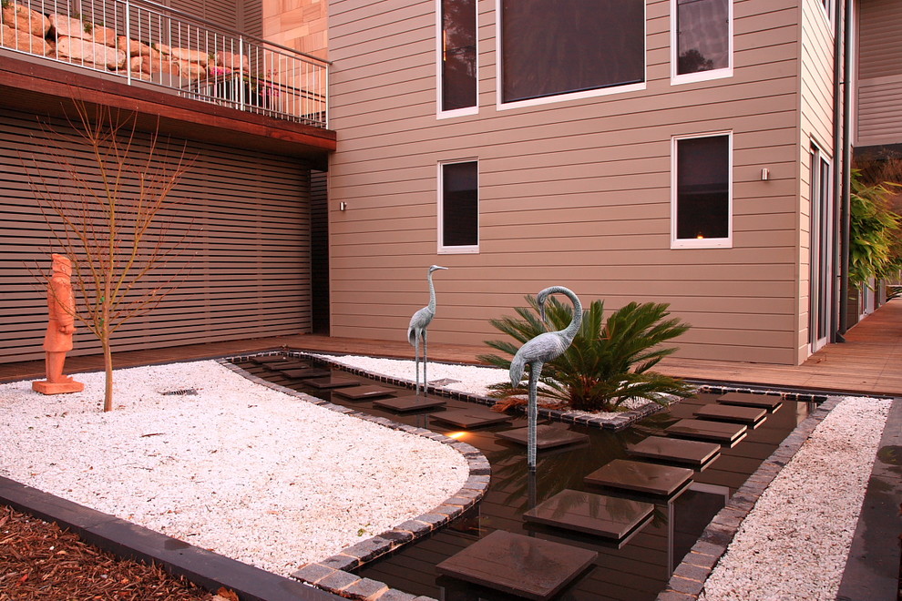 Small tropical side yard partial sun garden in Sydney with a water feature.