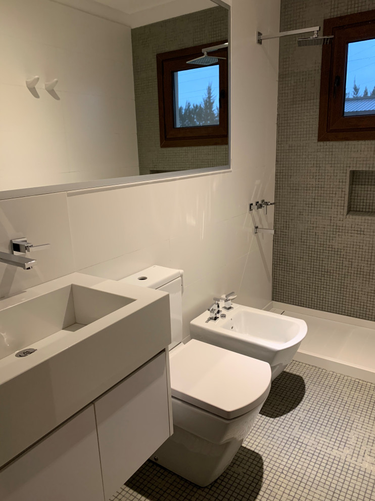 他の地域にある小さなコンテンポラリースタイルのおしゃれな浴室 (フラットパネル扉のキャビネット、白いキャビネット、ドロップイン型浴槽、バリアフリー、分離型トイレ、グレーのタイル、モザイクタイル、白い壁、モザイクタイル、一体型シンク、クオーツストーンの洗面台、青い床、引戸のシャワー、白い洗面カウンター、シャワーベンチ、洗面台1つ、造り付け洗面台) の写真