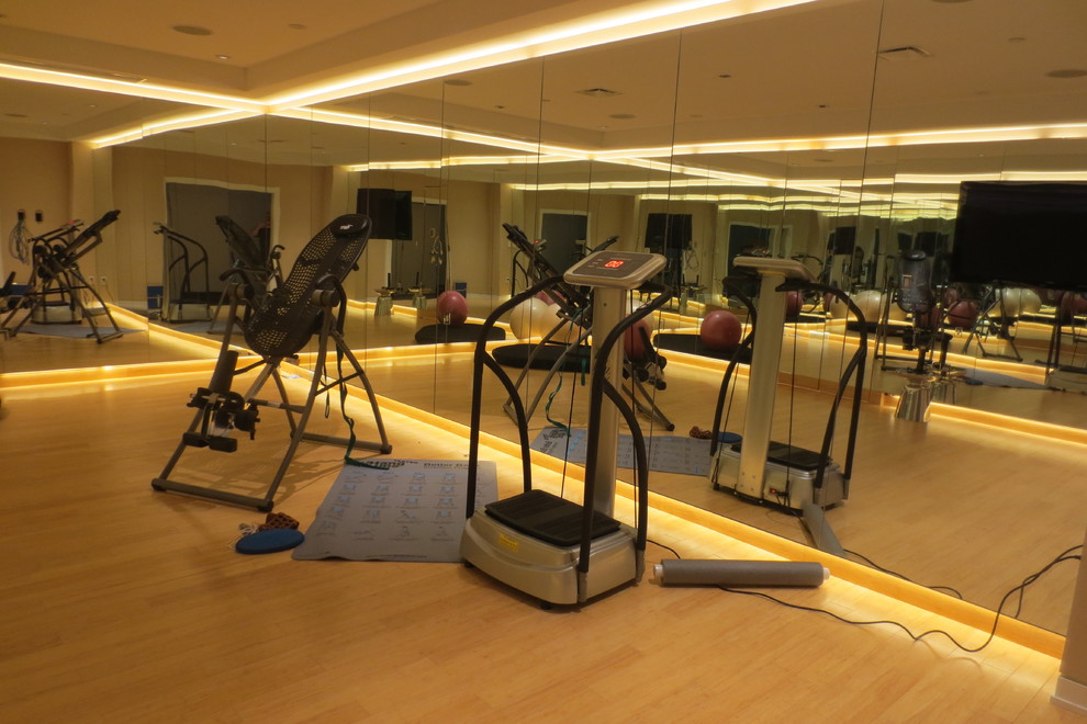 This is an example of a mid-sized contemporary multipurpose gym in Philadelphia with beige walls and bamboo floors.