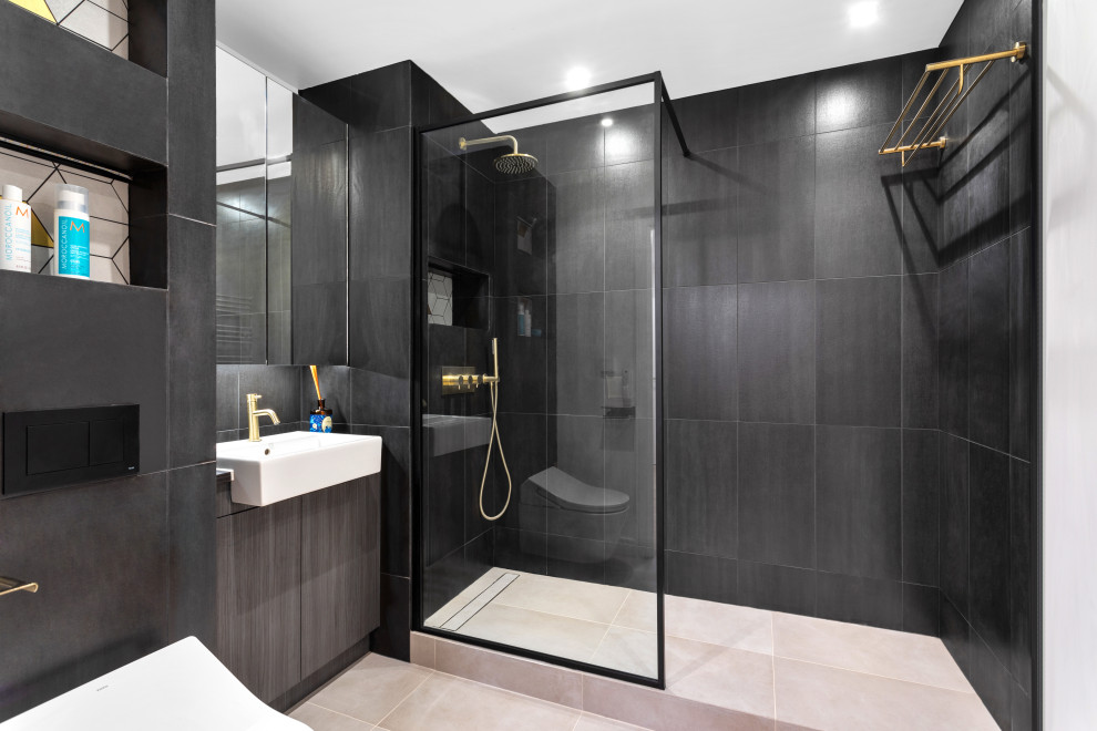 Design ideas for a mid-sized modern kids bathroom in London with an open shower, a one-piece toilet, black tile, ceramic tile, black walls, porcelain floors, a drop-in sink, grey floor, an open shower, a niche, a single vanity and a built-in vanity.
