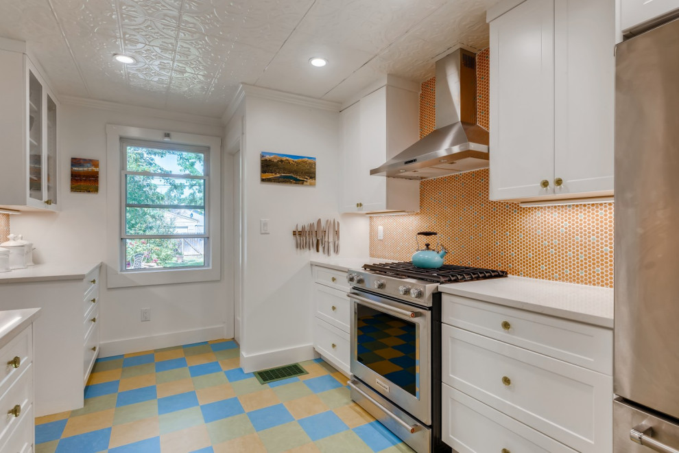 Design ideas for a small galley separate kitchen in Denver with a farmhouse sink, shaker cabinets, white cabinets, quartz benchtops, orange splashback, mosaic tile splashback, stainless steel appliances, linoleum floors, no island, blue floor, white benchtop and recessed.