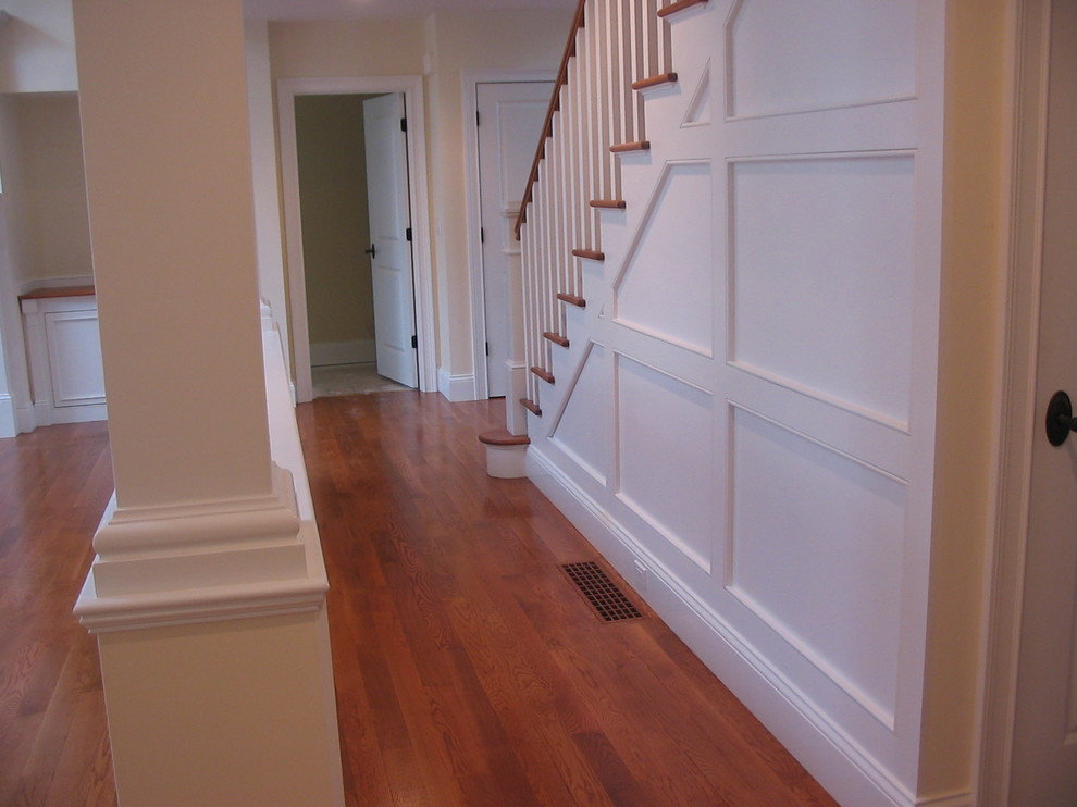 Mid-sized traditional wood straight staircase in Boston with painted wood risers and wood railing.