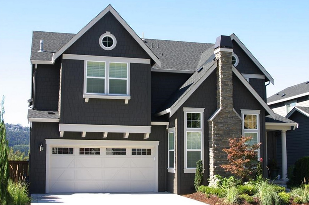 This is an example of an arts and crafts three-storey brown exterior in Seattle with vinyl siding.