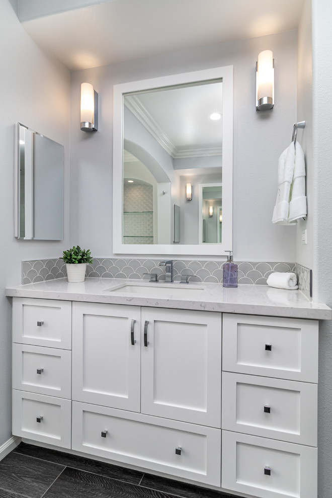Design ideas for a large traditional master bathroom in Los Angeles with shaker cabinets, white cabinets, a freestanding tub, gray tile, glass tile, white walls, porcelain floors, an undermount sink, engineered quartz benchtops, grey floor and white benchtops.