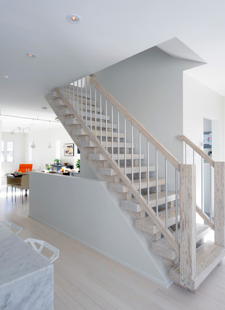 Photo of a mid-sized scandinavian wood straight staircase in Ottawa with open risers.