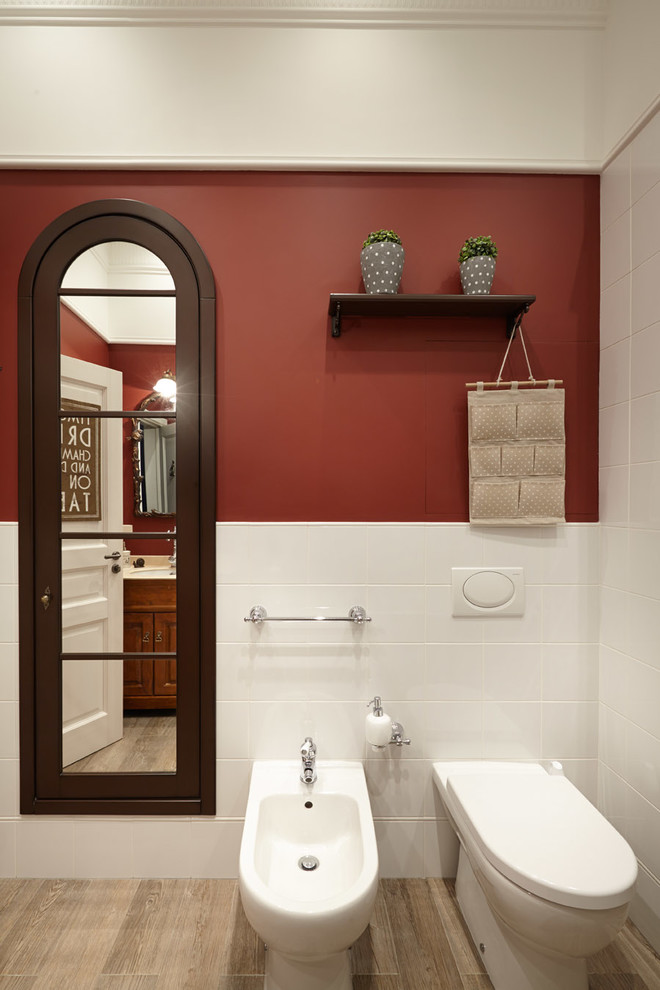 This is an example of a mid-sized traditional powder room in Moscow with white tile, ceramic tile, red walls, ceramic floors and a bidet.