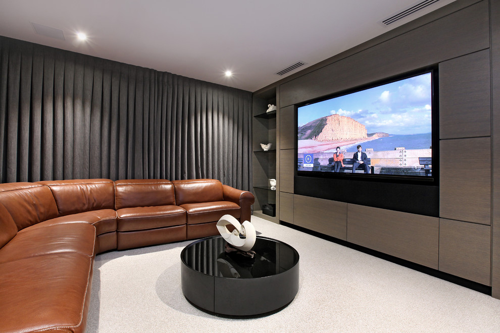 This is an example of a contemporary home theatre in Auckland with grey walls, carpet and white floor.