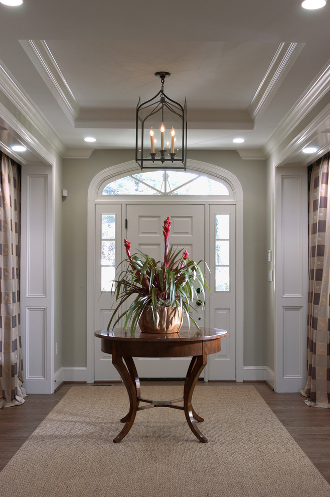 Inspiration for a mid-sized arts and crafts foyer in DC Metro with grey walls, medium hardwood floors, a single front door and a white front door.