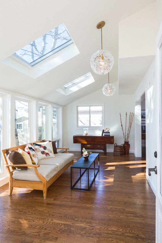 Photo of a mid-sized country sunroom in Denver with medium hardwood floors, no fireplace and a skylight.