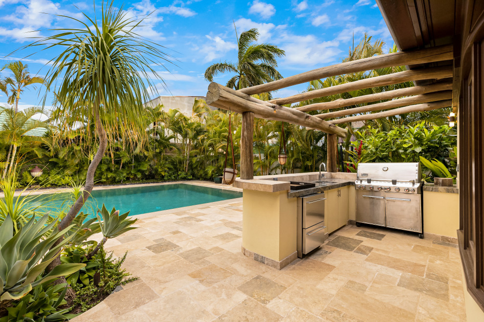 Island style tile patio kitchen photo in Hawaii with a pergola