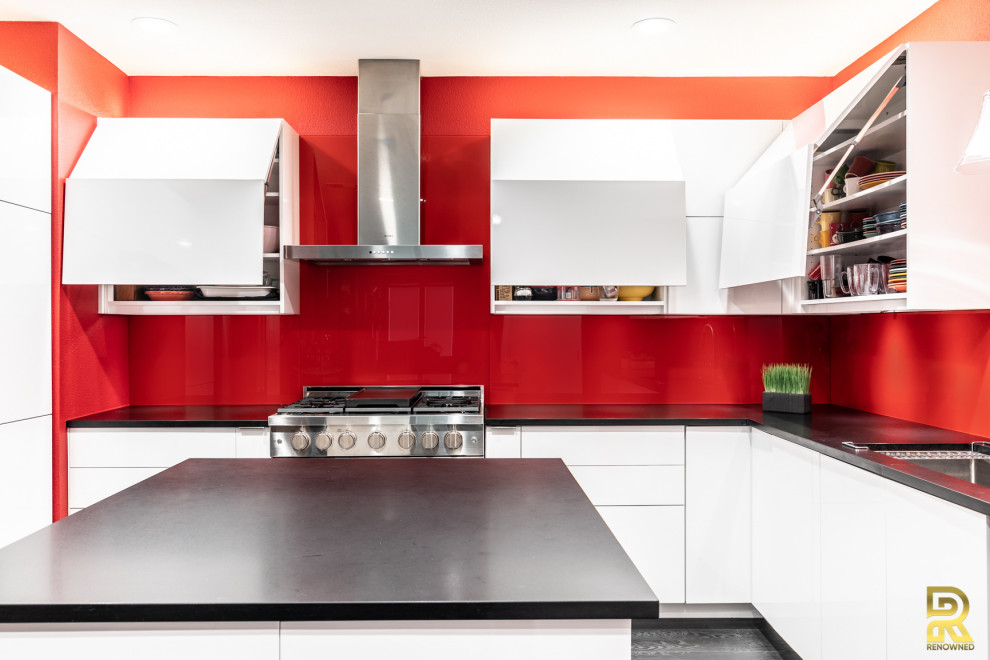 Photo of a mid-sized contemporary u-shaped kitchen in Dallas with an undermount sink, flat-panel cabinets, white cabinets, quartz benchtops, red splashback, glass tile splashback, stainless steel appliances, ceramic floors, with island, black floor and black benchtop.
