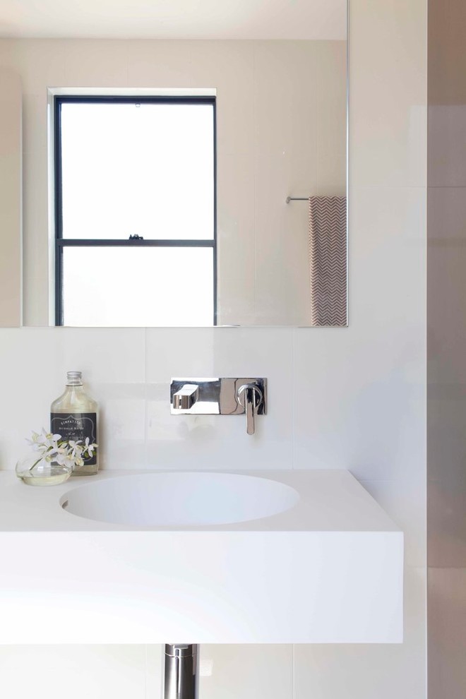 Inspiration for a large contemporary master bathroom in Brisbane with white tile, ceramic tile, white walls, a wall-mount sink, solid surface benchtops and white benchtops.