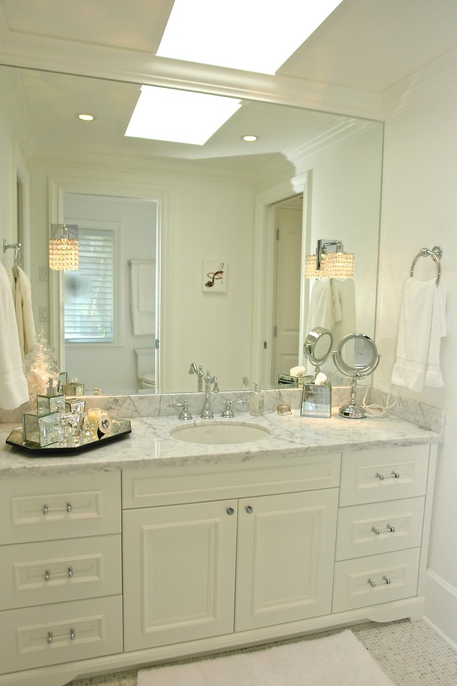 Photo of a mid-sized contemporary kids bathroom in Vancouver with an undermount sink, furniture-like cabinets, white cabinets, marble benchtops, a one-piece toilet, multi-coloured tile, mosaic tile, white walls and mosaic tile floors.