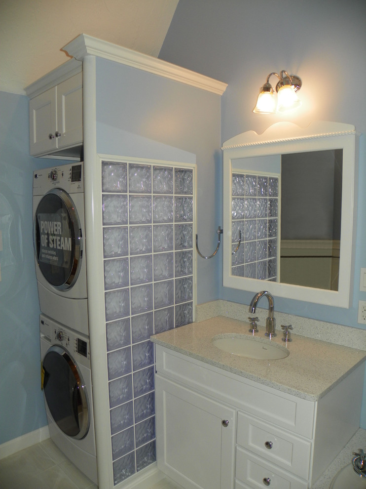 Mid-sized traditional 3/4 bathroom in Boston with an undermount sink, shaker cabinets, white cabinets, engineered quartz benchtops, a one-piece toilet, blue walls, porcelain floors and a laundry.