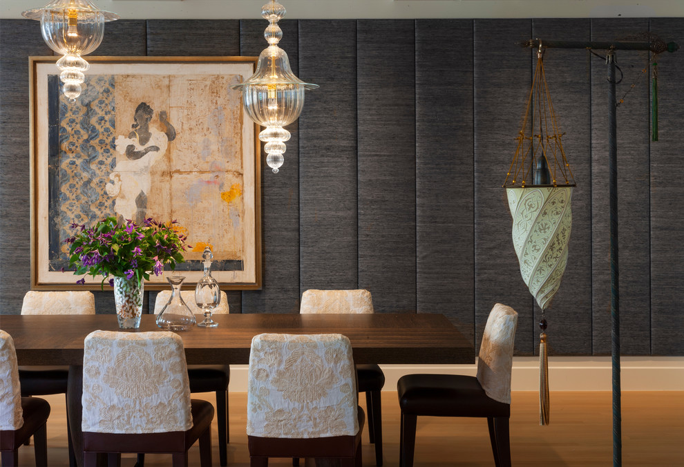 This is an example of a contemporary dining room in New York with grey walls and light hardwood floors.