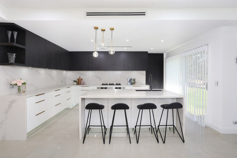 Modern kitchen in Sydney with an undermount sink, stainless steel appliances, porcelain floors and with island.
