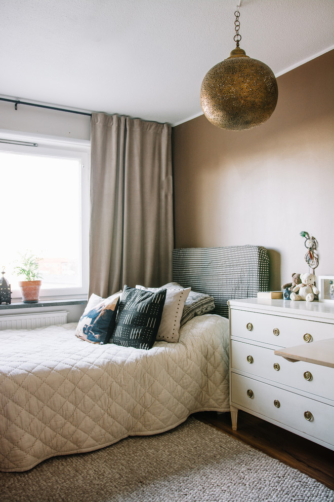 Photo of a mid-sized contemporary master bedroom in Stockholm with brown walls, medium hardwood floors and no fireplace.