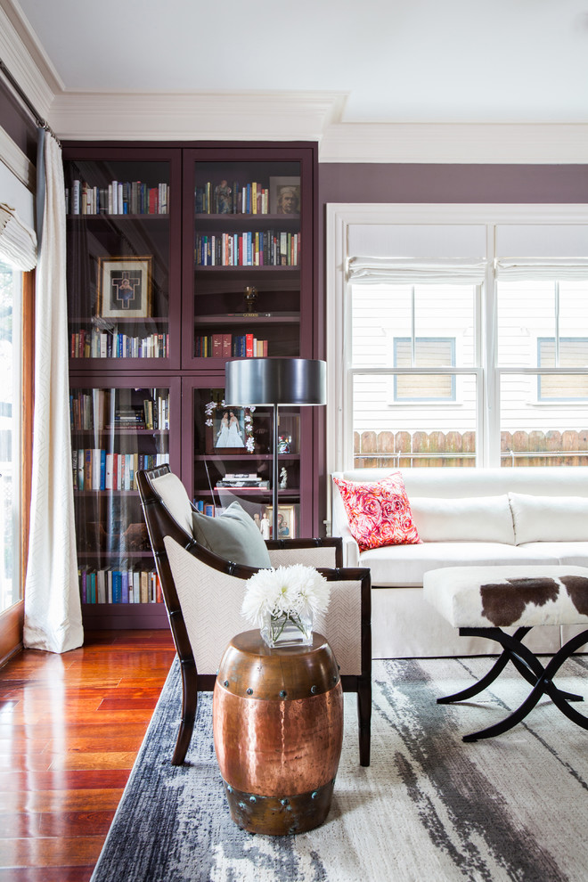 Design ideas for a transitional living room in Houston with a library and purple walls.