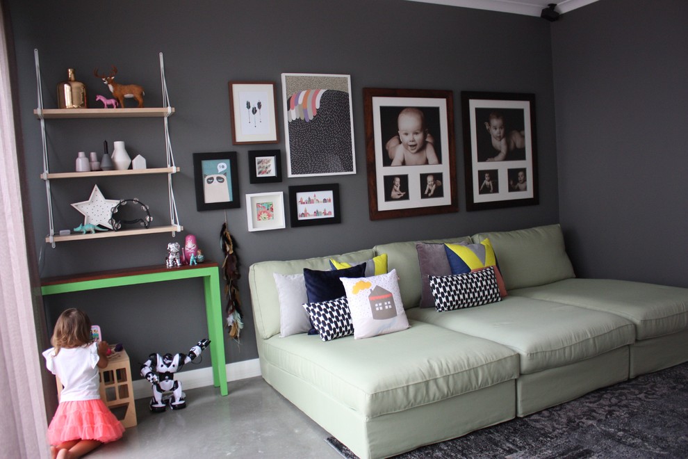 Photo of a large contemporary gender-neutral kids' playroom in Perth with grey walls and concrete floors.